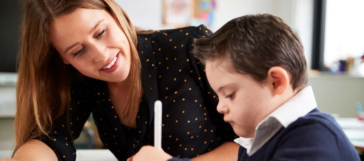 Volunteer working with young boy