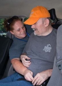 Care Giver Buckling Patient into Van